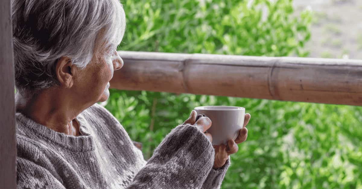 Older adult enjoying a quiet moment at home, highlighting independence and the importance of a home care safety checklist for seniors.